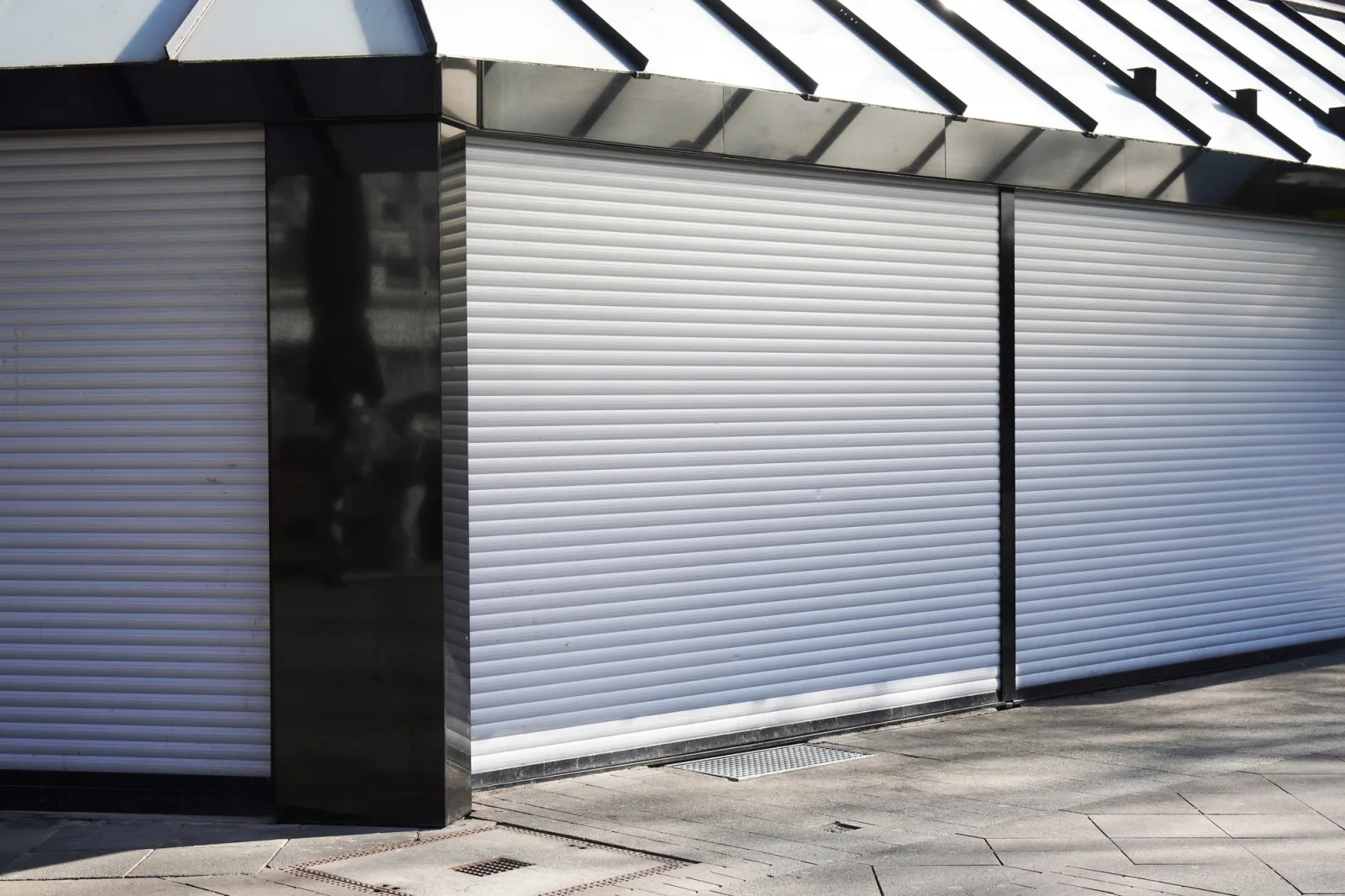 closed business shop or store front with roller shutters. economy crisis and recession concept.